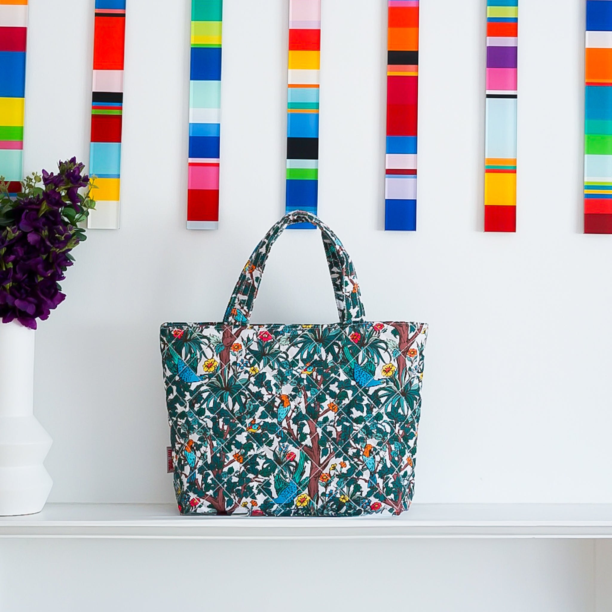 Lilt Tote Mellow Quilted Tote Maxi in Pop Floral bright floral dark background art print in front of modern geometric art